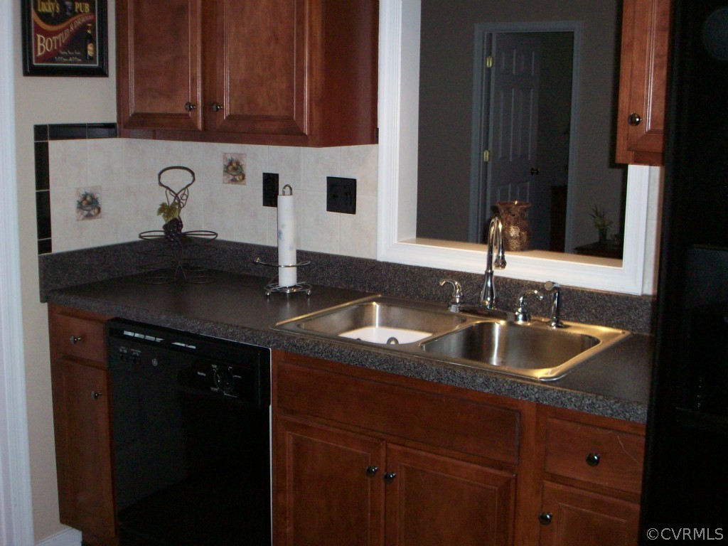 15813 Sandwave Road Chester, VA 23831 - Photo 8 of 24 a kitchen with a sink and cabinets