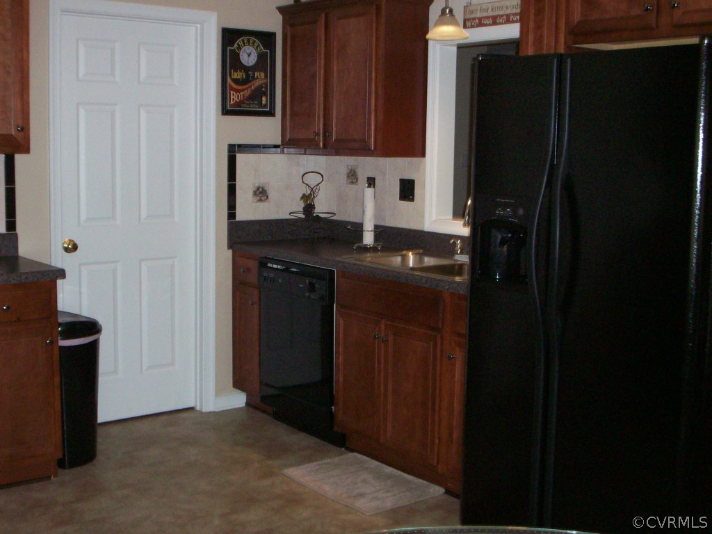15813 Sandwave Road Chester, VA 23831 - Photo 9 of 24 a kitchen with a sink and a refrigerator