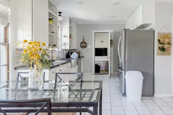 a living room with furniture a table and chairs