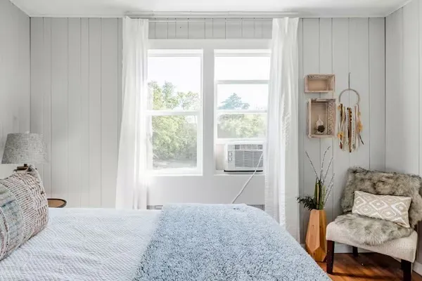 a bedroom with a bed and a window