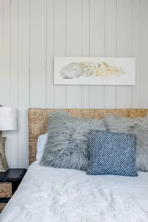 a bedroom with a bed and a painting on the wall