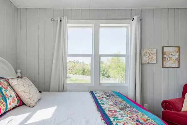 a bedroom with a bed and a window