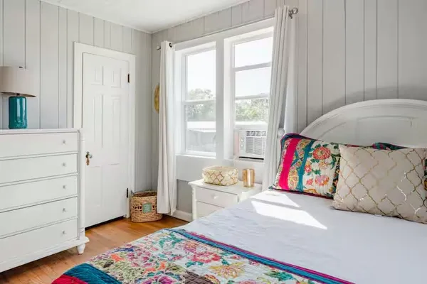 a bedroom with a bed and a mirror