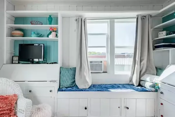 a bedroom with a bed and a window