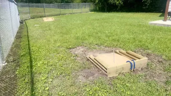 a backyard of a house with yard and outdoor seating