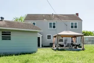 a front view of a house with a garden