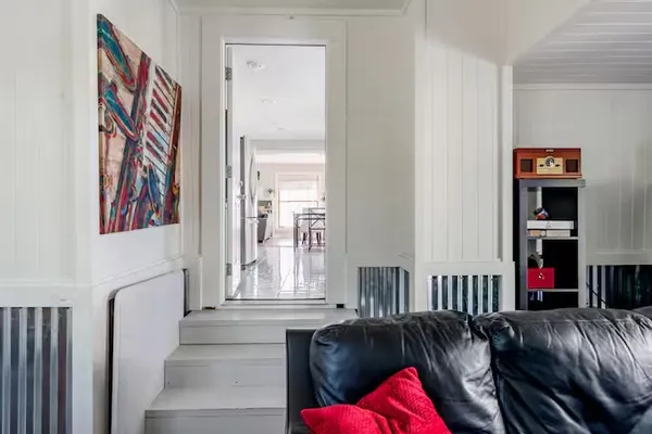 a living room with furniture and a book shelf