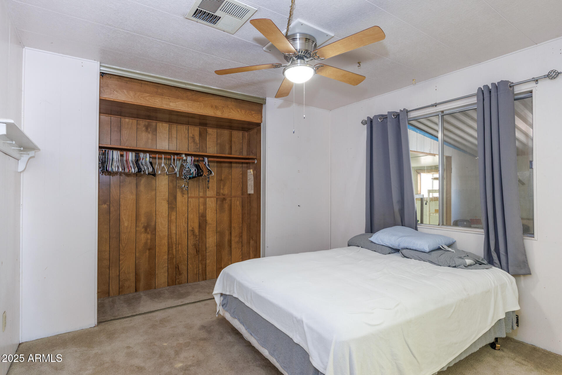 2100 North Trekell Road, Unit 144 Casa Grande, AZ 85122 - Photo 14 of 36 a bedroom with a bed and a chandelier