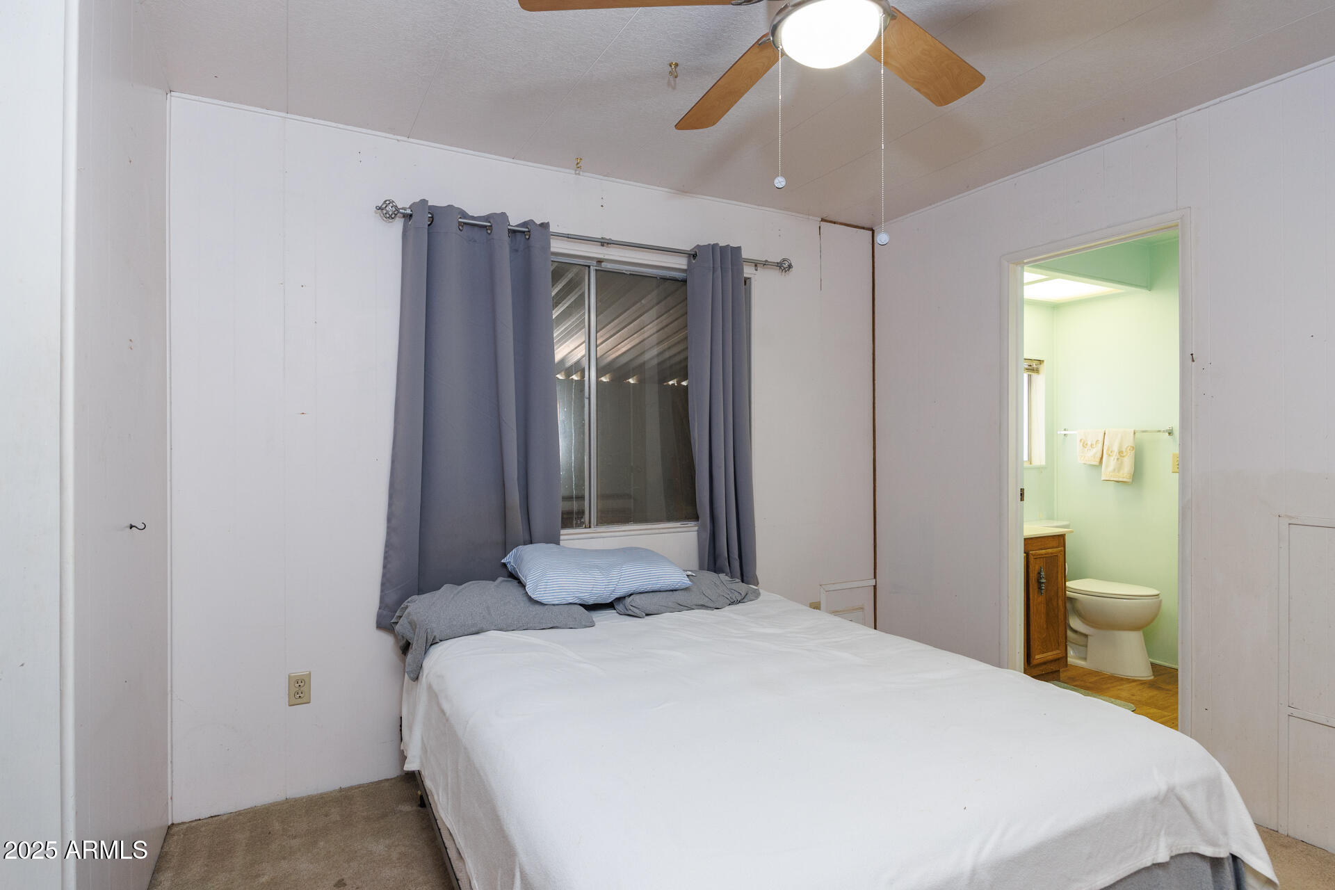 2100 North Trekell Road, Unit 144 Casa Grande, AZ 85122 - Photo 16 of 36 a bedroom with a bed and a chandelier
