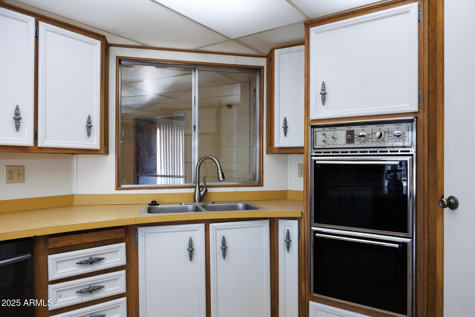 2100 North Trekell Road, Unit 144 Casa Grande, AZ 85122 - Photo 10 of 36 a kitchen with a refrigerator and a sink