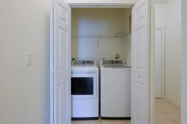 an aerial view of a house with a yard and lake view