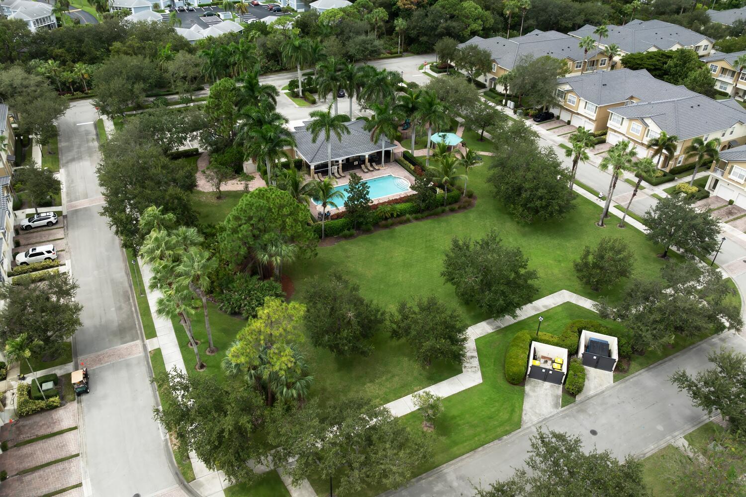 1561 Southeast Hampshire Way, Unit 104 Stuart, FL 34994 - Photo 22 of 23 an aerial view of a house with yard swimming pool and outdoor seating