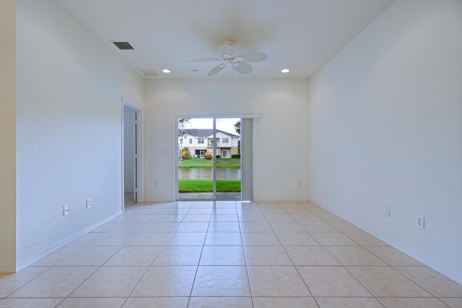 1561 Southeast Hampshire Way, Unit 104 Stuart, FL 34994 - Photo 6 of 23 a view of an empty room with a window