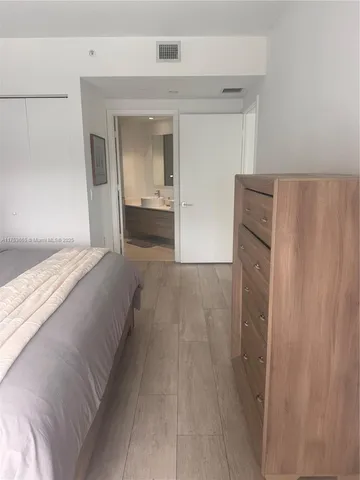a bedroom with a bed and a mirror