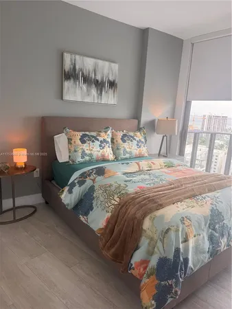 a bedroom with a bed and painting on the wall