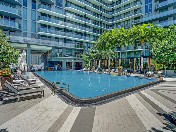 a view of a swimming pool with a lounge chairs