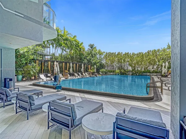 a view of a swimming pool with chairs