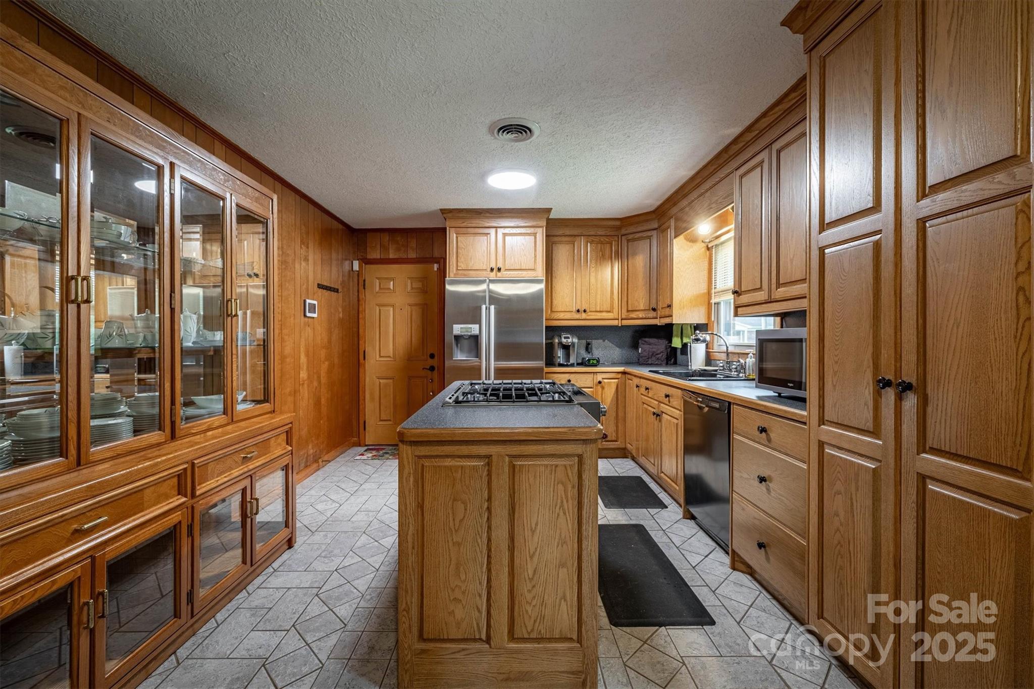 106 Gerald Road Morganton, NC 28655 - Photo 11 of 30 a kitchen with stainless steel appliances granite countertop a refrigerator a stove and a sink with wooden floor