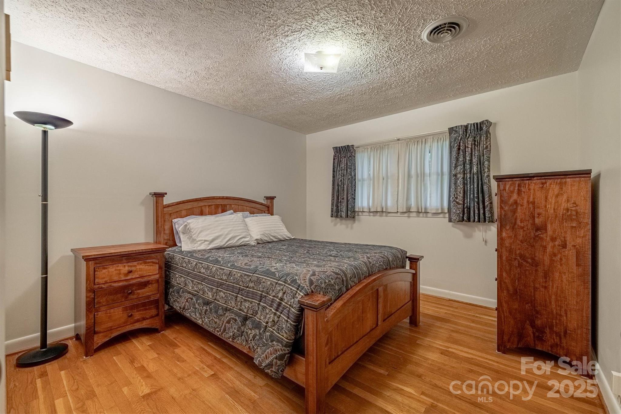 106 Gerald Road Morganton, NC 28655 - Photo 14 of 30 a bedroom with a bed and wooden floor
