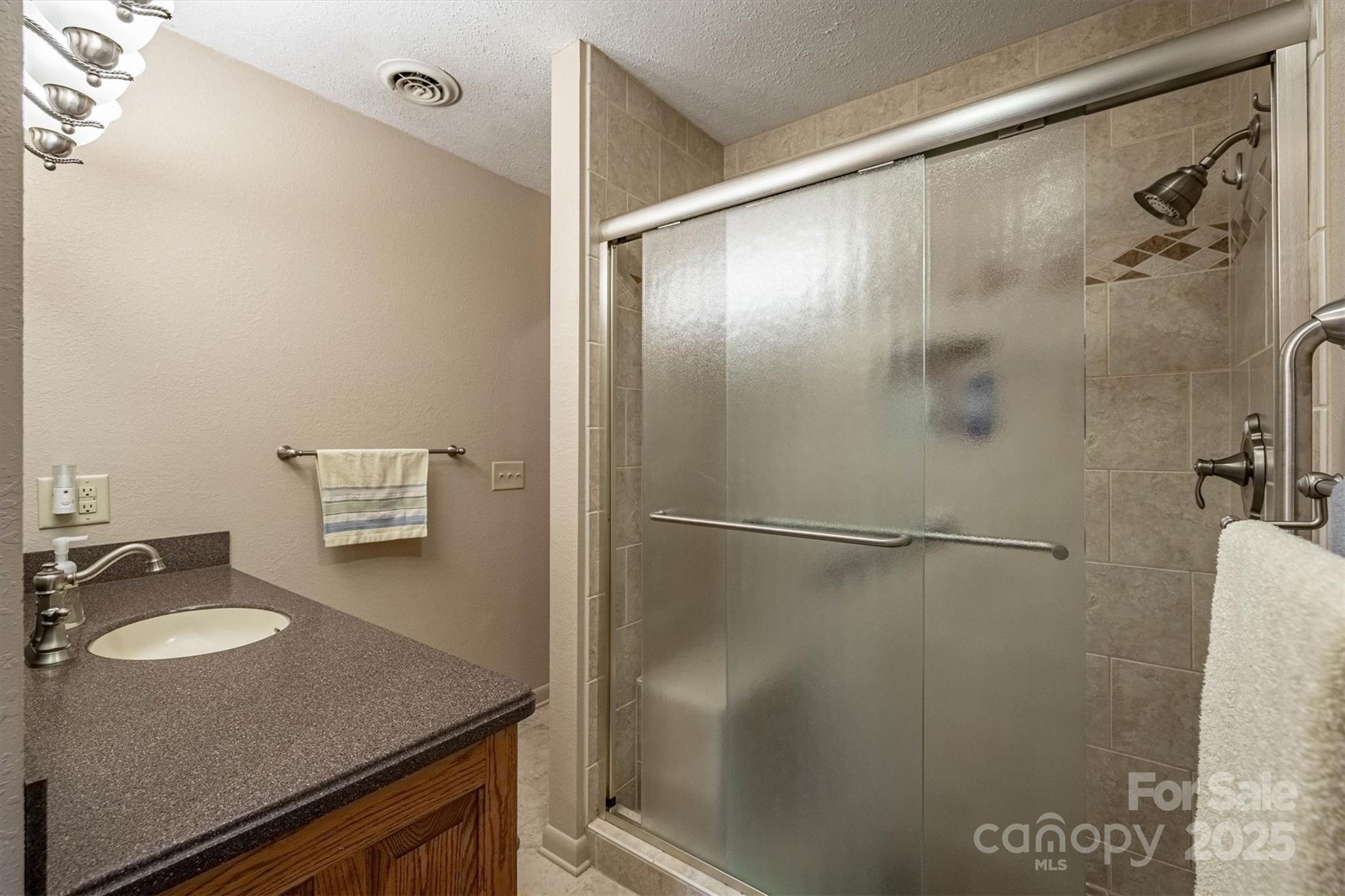 106 Gerald Road Morganton, NC 28655 - Photo 16 of 30 a bathroom with a granite countertop sink and a mirror
