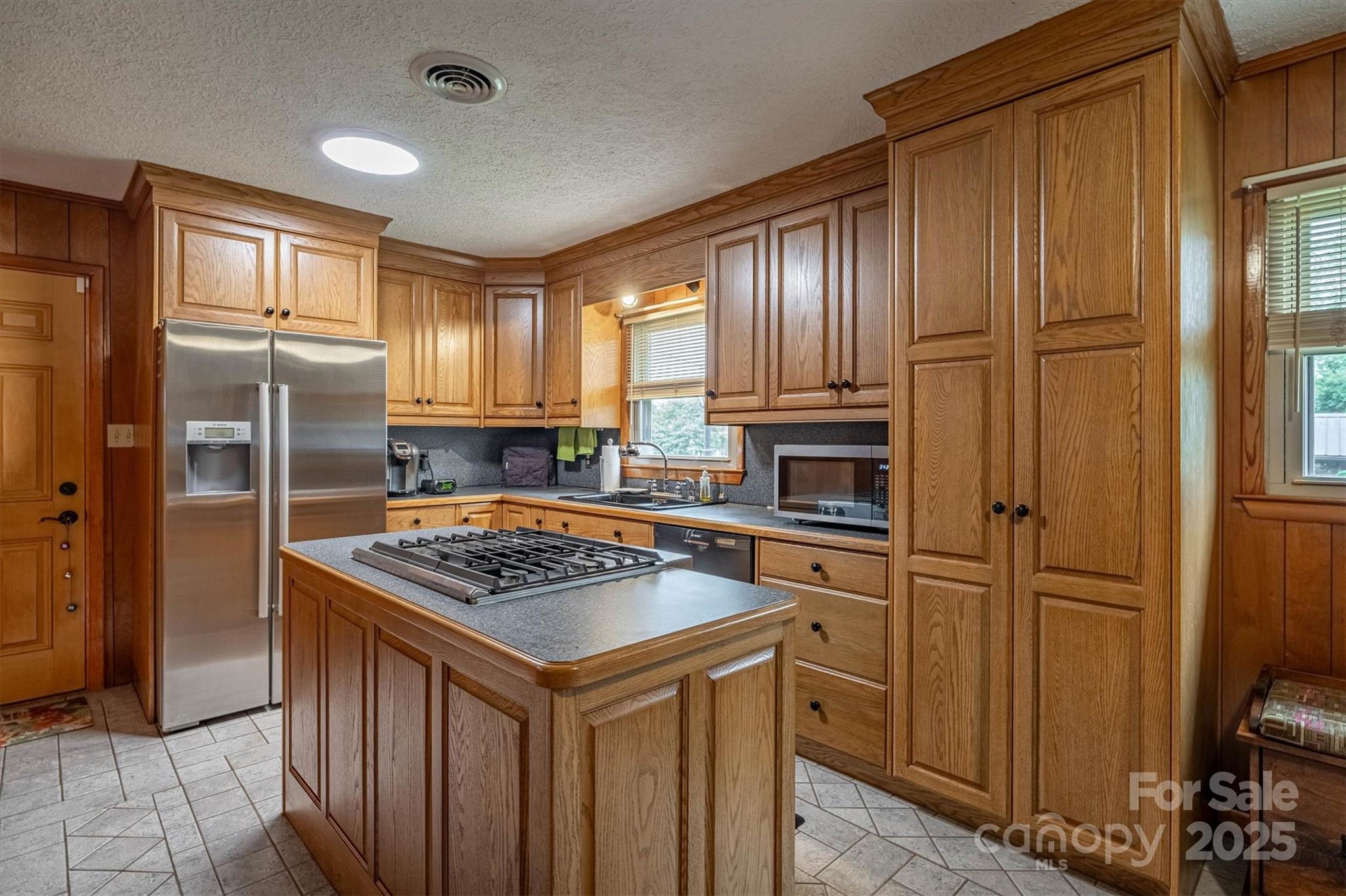106 Gerald Road Morganton, NC 28655 - Photo 10 of 30 a kitchen with stainless steel appliances granite countertop a refrigerator a sink dishwasher and wooden cabinets with wooden floor