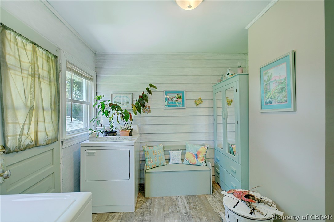 2442 Old Ferry Road Hudgins, VA 23076 - Photo 5 of 33 Bathroom with a tub, crown molding, and wood-type flooring