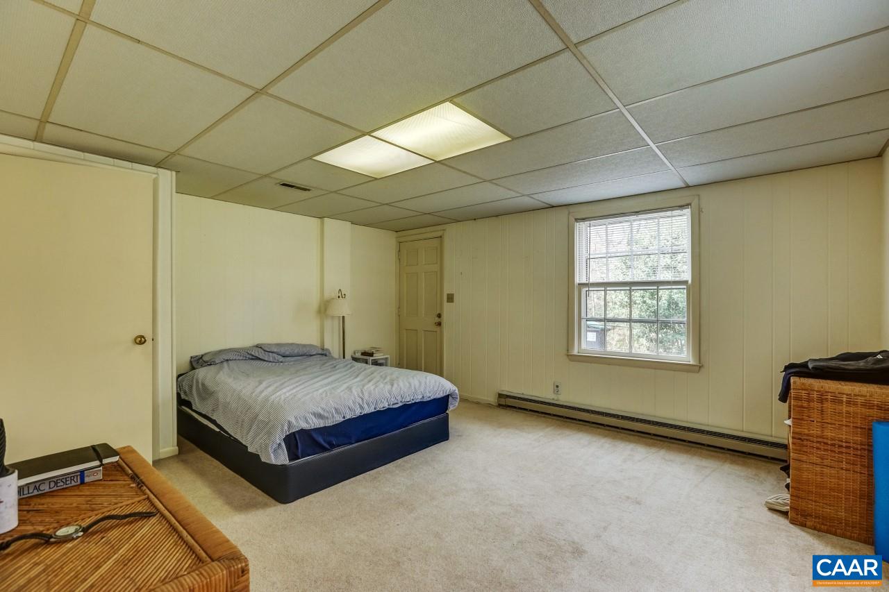 1503 Rugby Road Charlottesville, VA 22903 - Photo 28 of 40 a spacious bedroom with a bed and a window