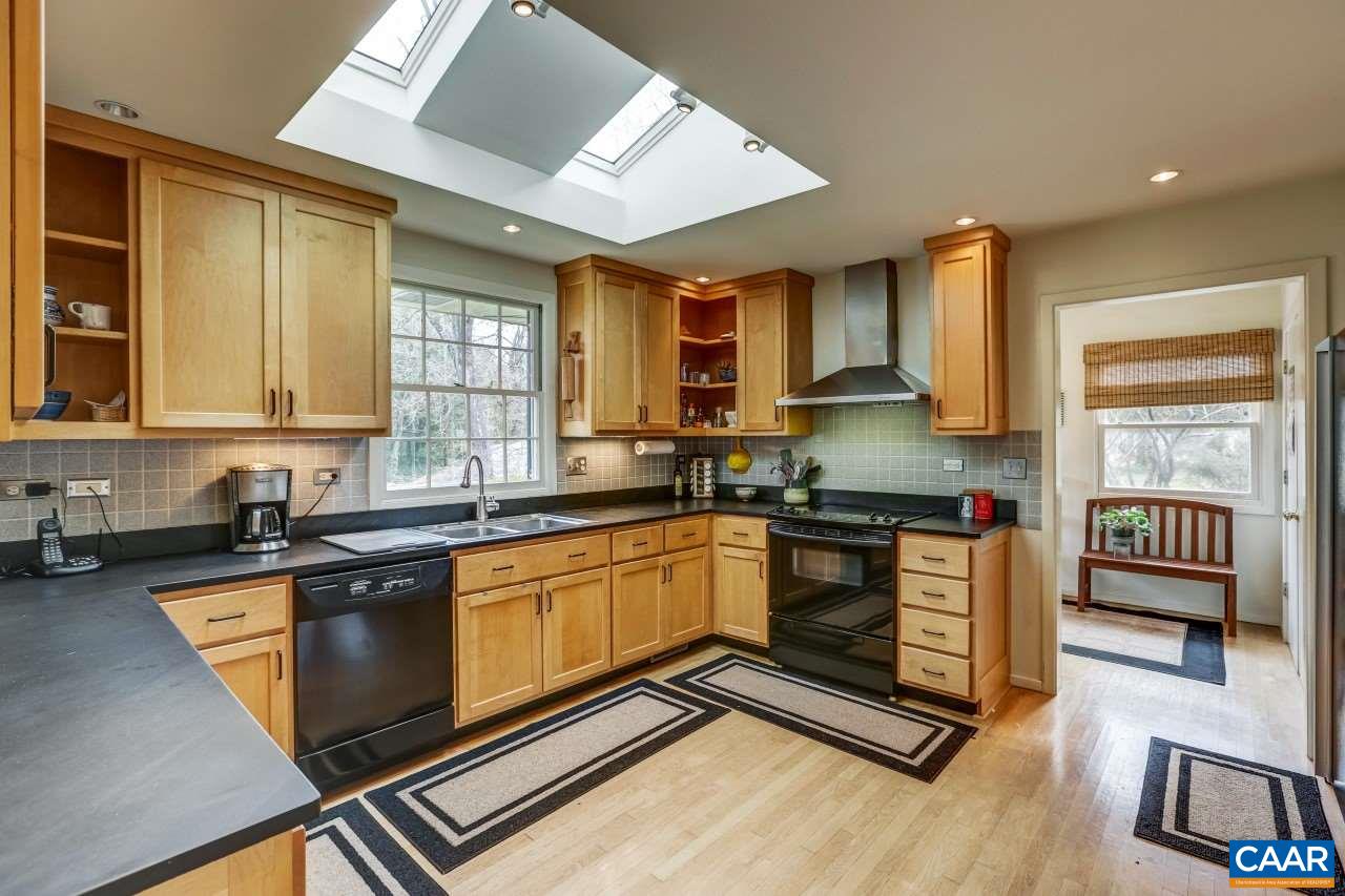 1503 Rugby Road Charlottesville, VA 22903 - Photo 8 of 40 a kitchen with granite countertop a stove a sink and a microwave