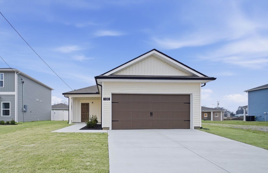 a front view of a house with a yard and garage