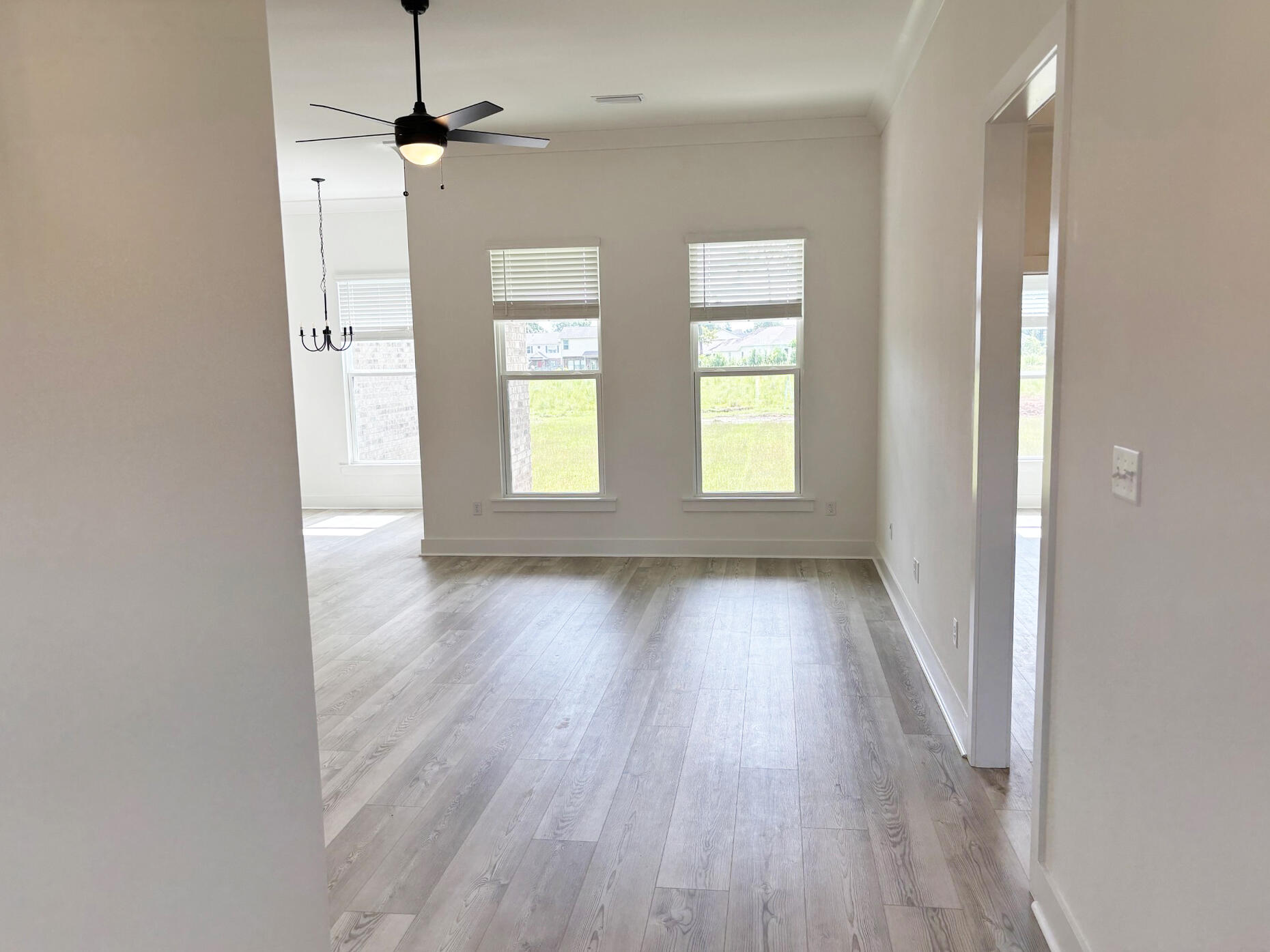 5800 Del Rio Crossing Crestview, FL 32539 - Photo 2 of 24 wooden floor in an empty room with a window