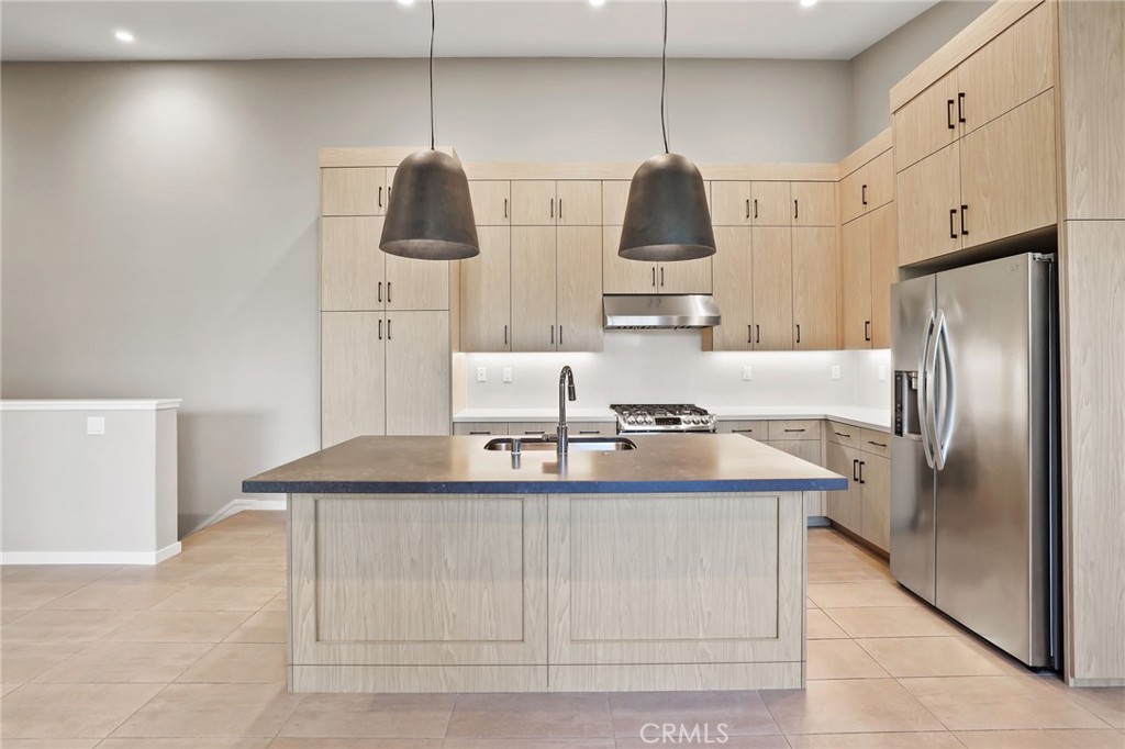 110 Coastal Garden Irvine, CA 92618 - Photo 1 of 33 a kitchen with stainless steel appliances granite countertop a sink and a refrigerator