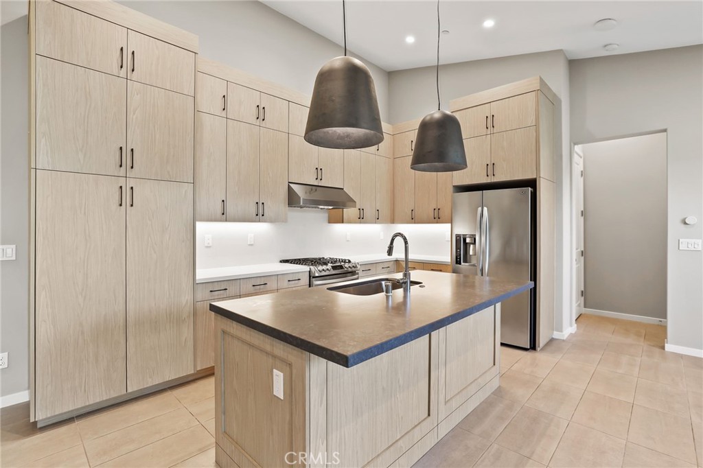110 Coastal Garden Irvine, CA 92618 - Photo 11 of 33 a kitchen with stainless steel appliances granite countertop a sink a stove and a refrigerator