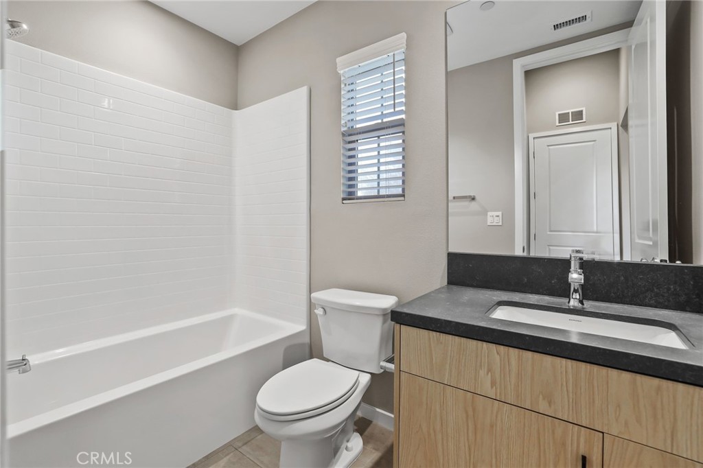 110 Coastal Garden Irvine, CA 92618 - Photo 16 of 33 a bathroom with a granite countertop sink toilet and shower