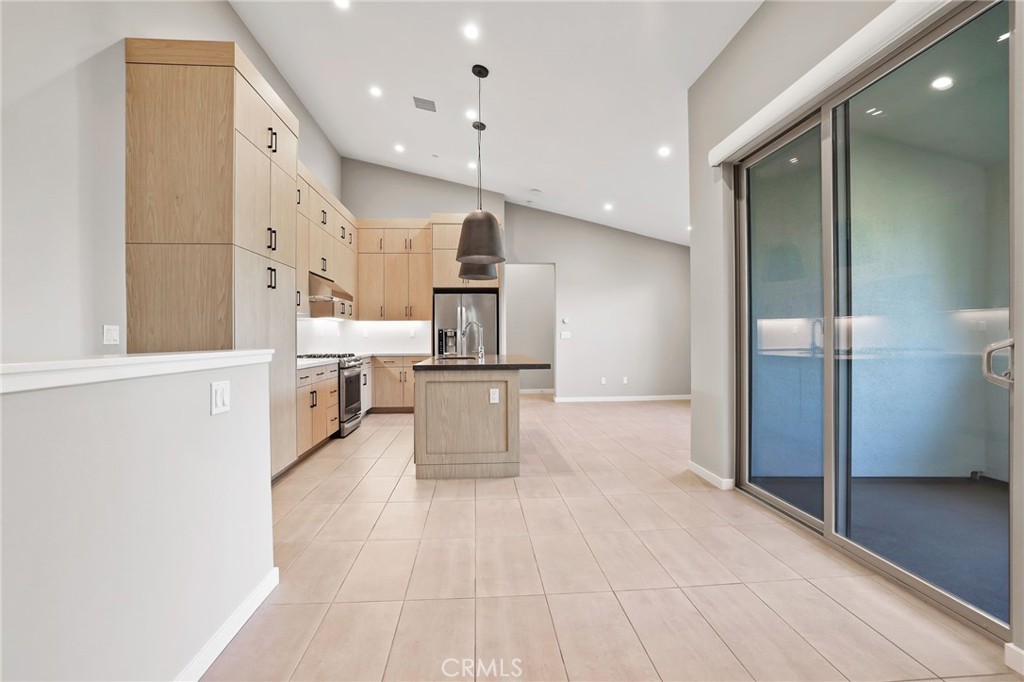 110 Coastal Garden Irvine, CA 92618 - Photo 6 of 33 a large white kitchen with cabinets and stainless steel appliances