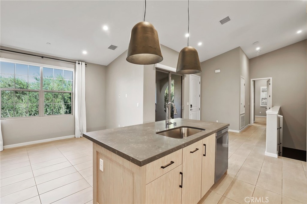 110 Coastal Garden Irvine, CA 92618 - Photo 7 of 33 a kitchen with granite countertop a sink a counter top space and stainless steel appliances