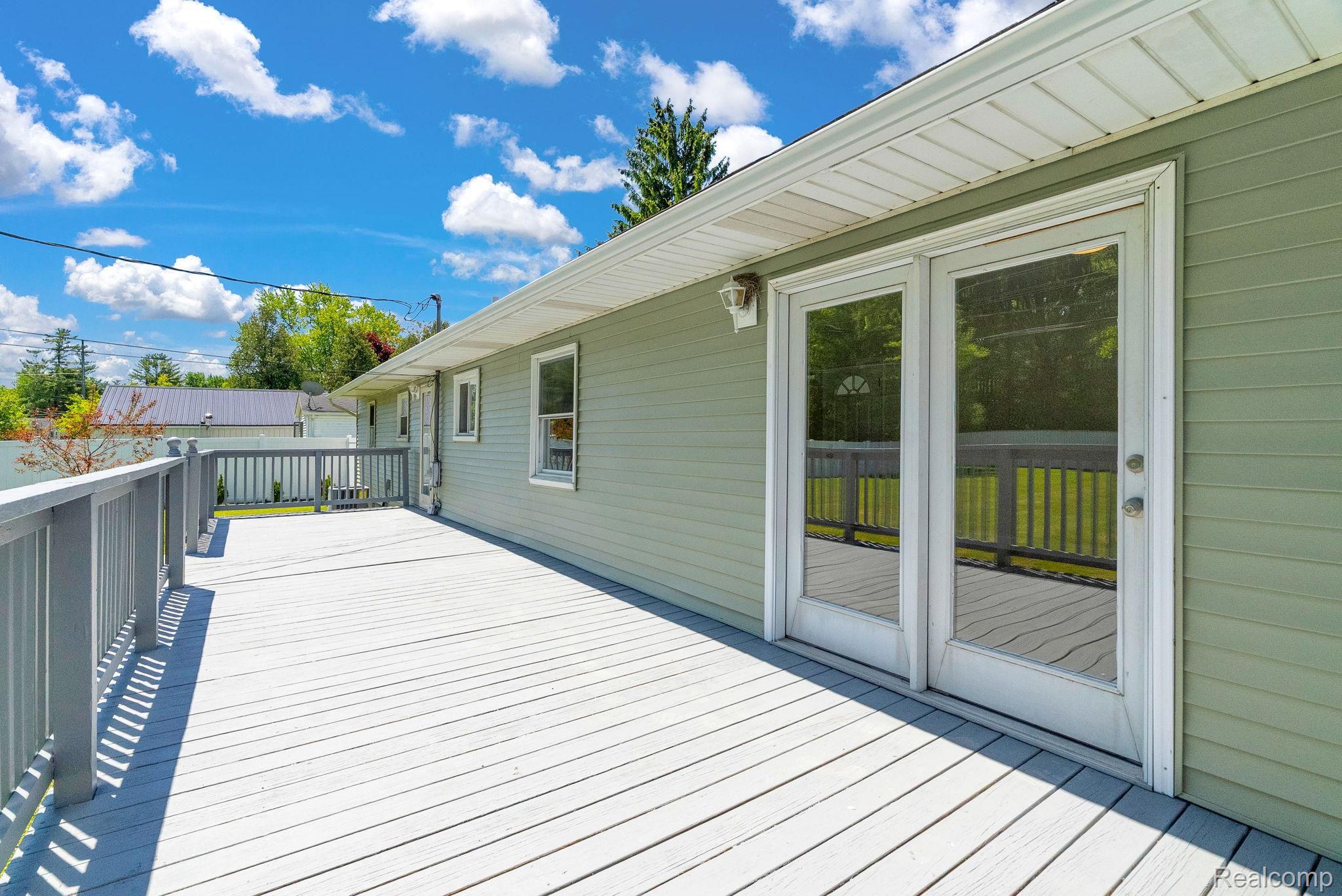 4046 State Road Fort Gratiot, MI 48059 - Photo 37 of 38 Expansive exterior deck featuring durable wood-finish planks and a painted railing system