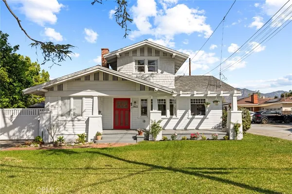 a front view of a house with a yard patio and swimming pool