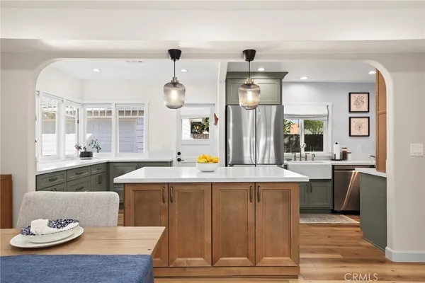 a living room with granite countertop kitchen island furniture and a chandelier