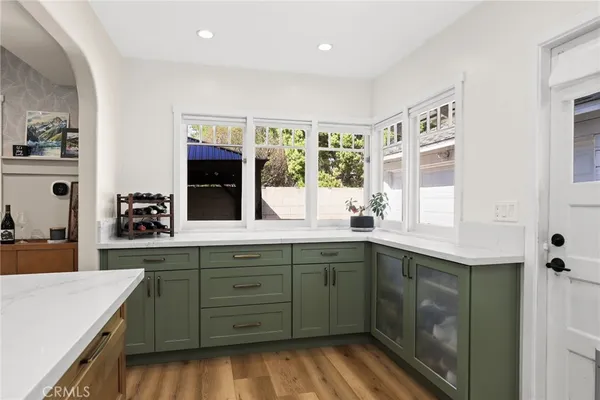 a kitchen with a sink cabinets and window