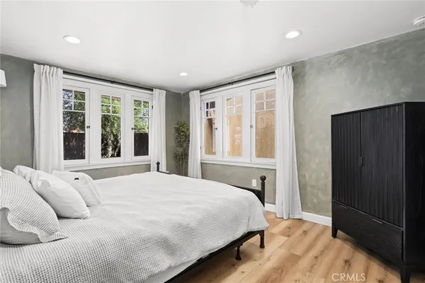 a bedroom with a large bed and a window