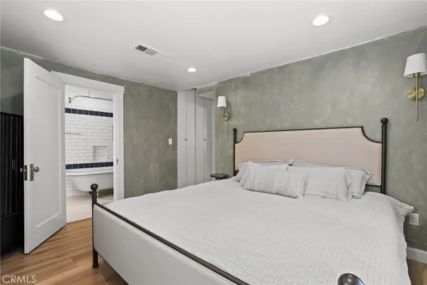 a bedroom with a bed and a dresser