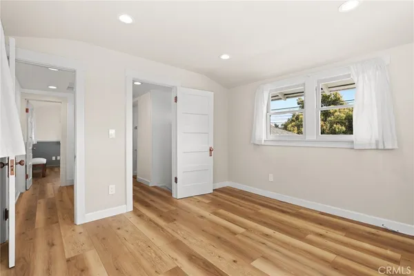 wooden floor in a room next to a window