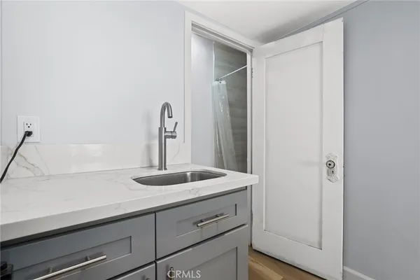 a kitchen with a sink and a mirror