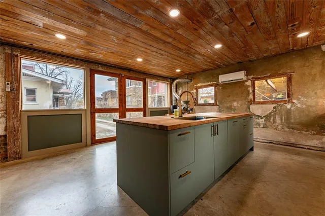 a kitchen with sink and cabinets