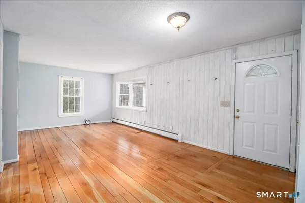 wooden floor in an empty room with a window