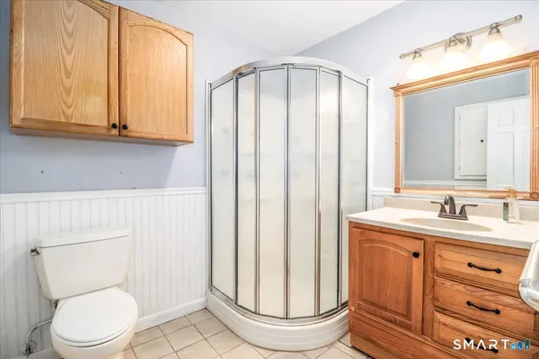 a bathroom with a toilet a sink and a mirror
