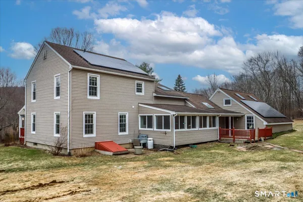 a view of a house with a yard in front of it