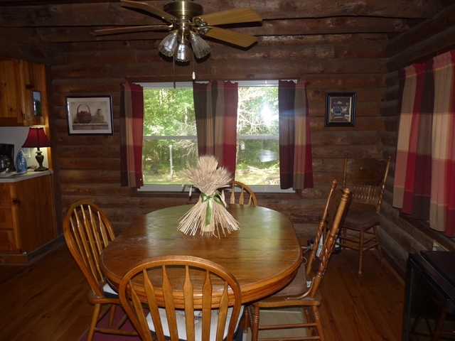 340 Holloman Road Gray, GA 31032 - Photo 14 of 22 a dining room with furniture a chandelier and wooden floor