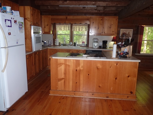 340 Holloman Road Gray, GA 31032 - Photo 20 of 22 a kitchen with wooden cabinets and refrigerator