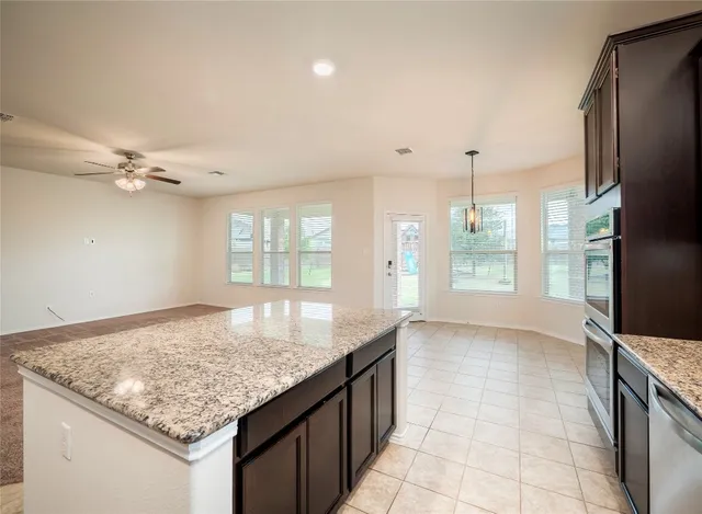 a kitchen with stainless steel appliances granite countertop a sink and a granite counter tops